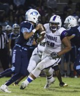 Lemoore's Noah Wright keys on Ranger quarterback Frankie Ayon in 31-14 loss Friday night.